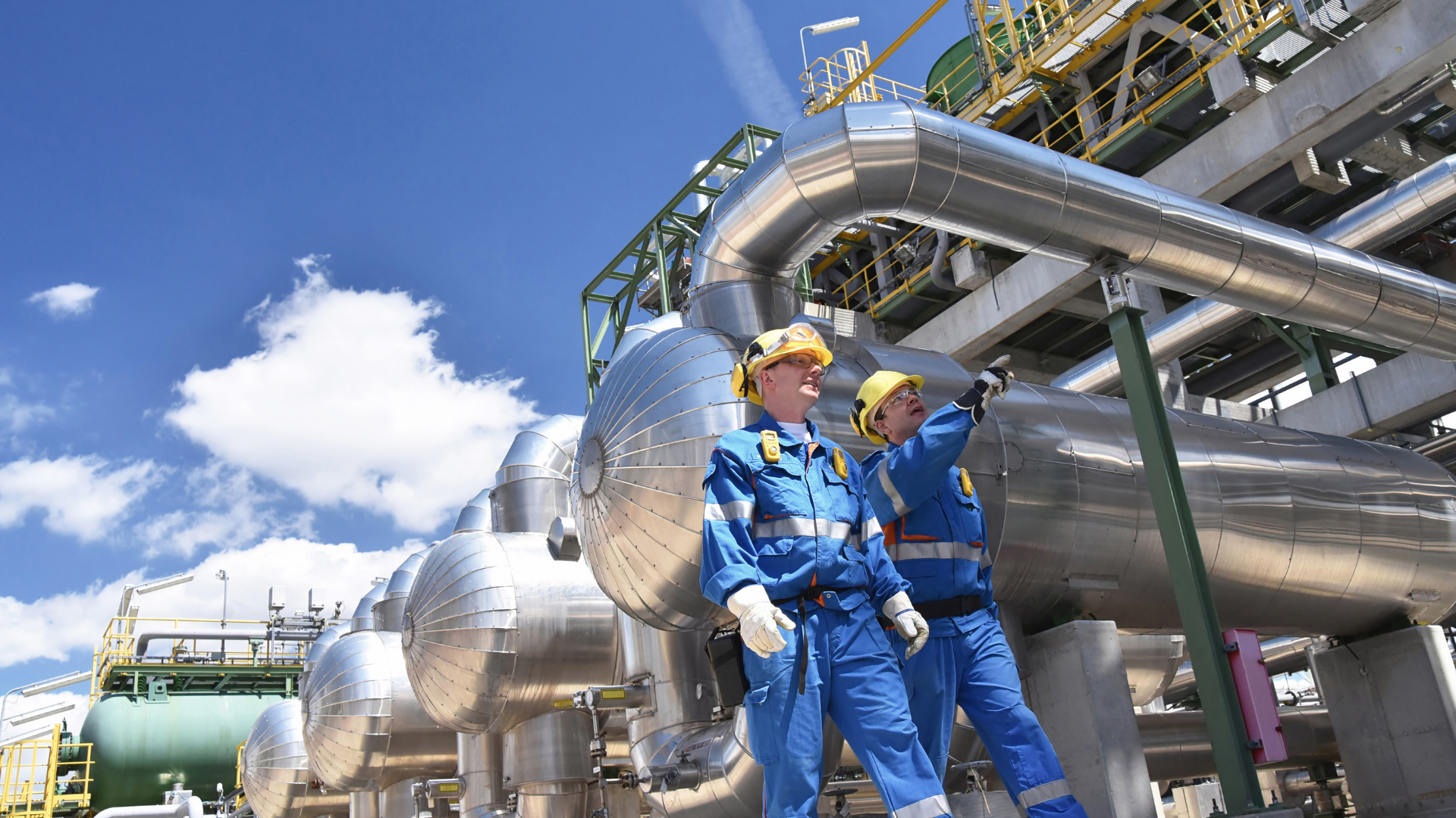 Two engineers outside outside of processing plant